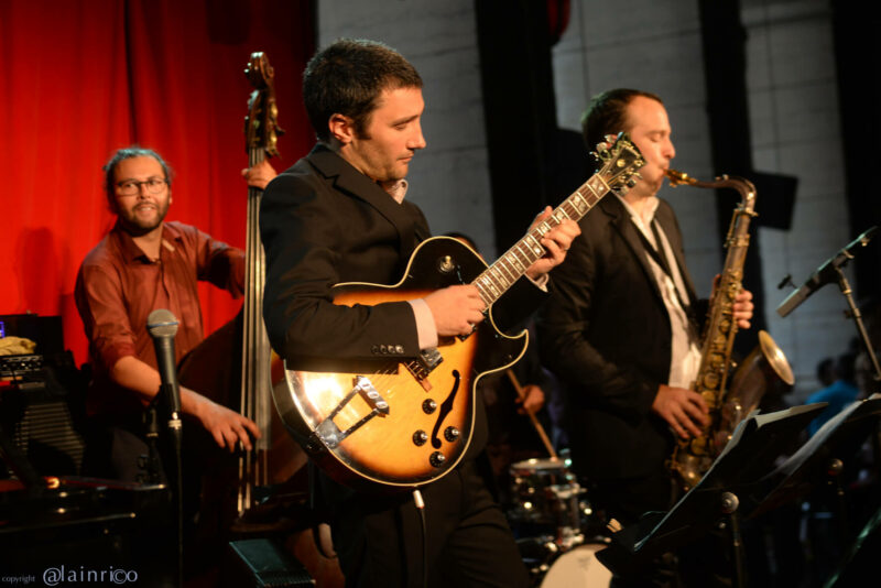 trio jazz à lyon avec guitare, saxophone et contrebasse, pendant un concert au péristyle de l'opéra